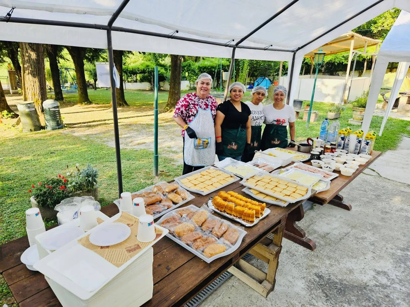 Voluntarias que preparan el desayuno bajo un toldo